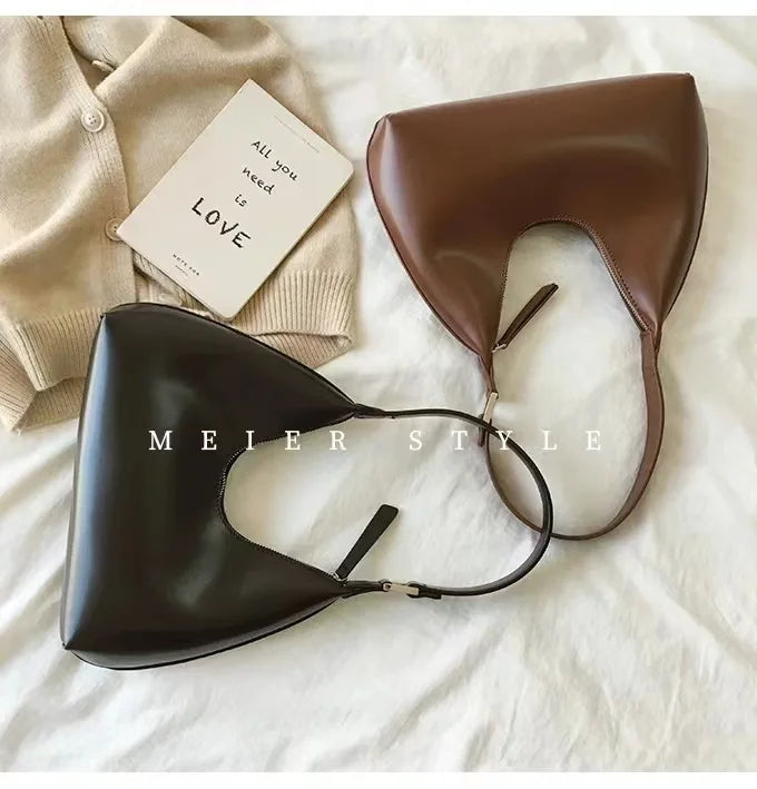 Elegant and sophisticated half-moon shaped handbags.